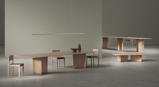 Wooden tables and chairs in a minimalist room.
