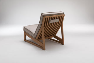Wooden lounge chair with cushioned seat.
