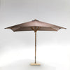 Brown patio umbrella with wooden pole.