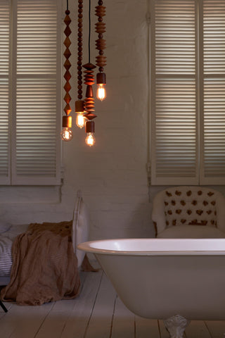Braund wooden pendant lights above bathtub