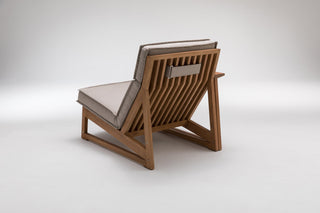 Wooden lounge chair with beige cushions.