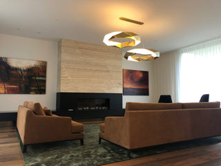 Living room with fireplace, sofas, and art.