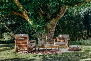 Didier TanGuor outdoor seating under a large tree