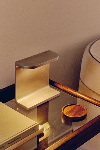 Modern brass Parcta9047 bedside lamp on glass table