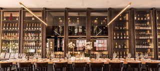Restaurant bar with wine bottles and glasses.