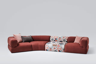 Red sectional sofa with pillows.