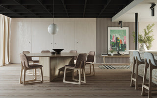 Dining room with table, chairs, and artwork.