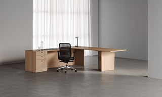 Wooden desk with chair in a bright room.