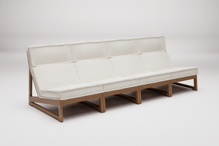 Long white sofa with wooden frame.