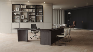 Modern office with desk, chairs, and built-in shelving.