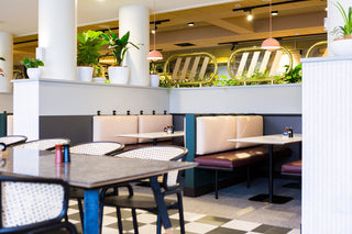 Restaurant interior with booths, mirrors, and plants - 7T5A3276-copy