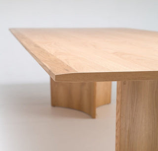 Wooden dining table with square legs.
