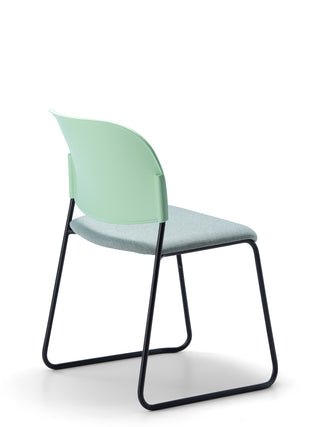 Advanta_Lumia-83 modern chair with a green backrest and black frame on a white background