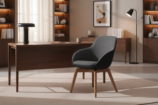 Dark gray upholstered chair with wooden legs on a white background