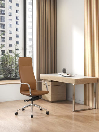 Modern office setup with a desk and Million tan high back chair in a room with large windows.