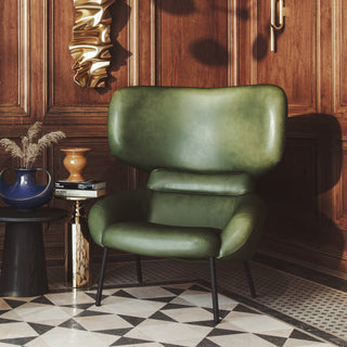 Green leather wingback chair in room setting