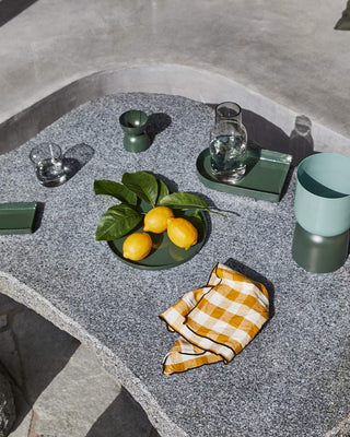 Green serving tray with lemons and glassware