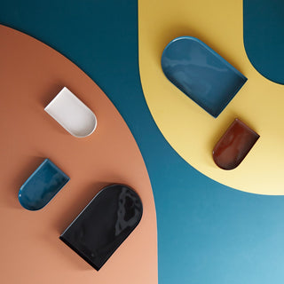 Arc-shaped ceramic trays in various colors