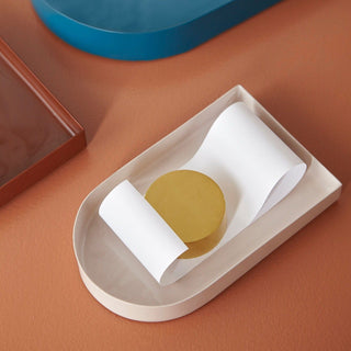 Beige tray with gold circle and rolled paper