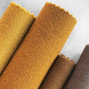Atlas fabric rolls in various warm colors