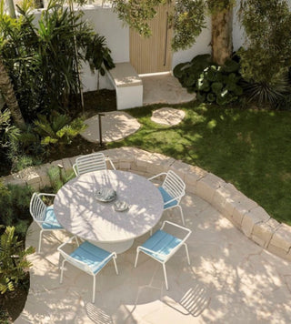 outdoor patio with round table and chairs.