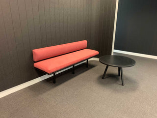 Red banquette seating and table in Greenbox Plasson