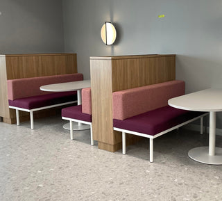 Banquette seating in Melbourne cafe with round tables.