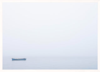 Blue boat in white frame on calm water