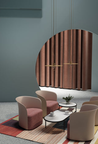Modern lounge area with armchairs and rug.