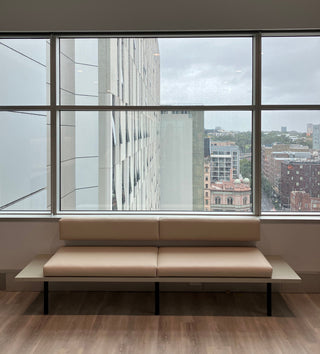 BrightHR office interior with city view and bench.