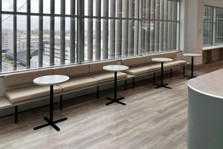 BrightHR office seating area with tables and window view