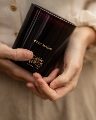 Bush Magic scented candle held in hands