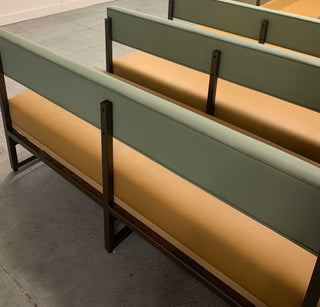 Green benches with tan cushions