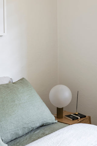 Catapult Superestate bedroom corner with globe lamp and pillow