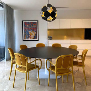 Modern dining room with black table and yellow chairs
