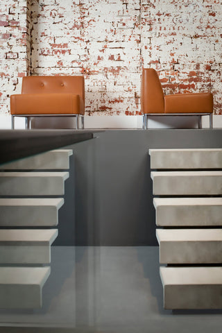 Modern connected sofas against brick wall