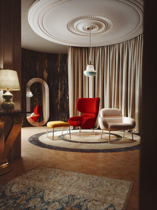 Modern family room with red and cream chairs.