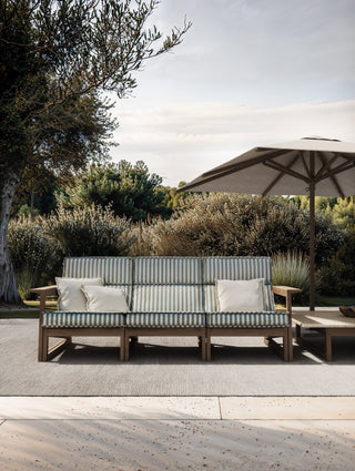 Tan Guor Residence I outdoor patio with sofa and umbrella.