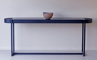 Modern console table with bowl decor.