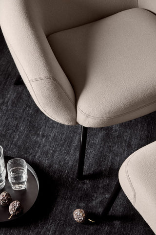 Didier armchair, August 2021, close-up of beige chair and black tray.