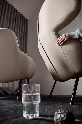 Modern chairs, hand, glass of water, and decor