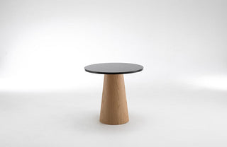 Didier LIQUEUR Table (2021) with black top and wooden base.