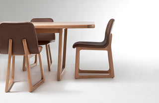 Wooden table with four matching chairs on a white background