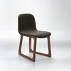 Chair with dark brown seat and wooden legs on a white background