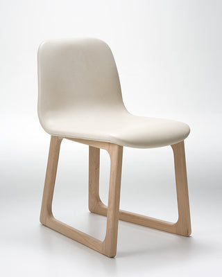 Chair with white seat and light wood legs on a white background