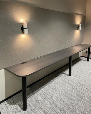 Long conference table with wall sconces