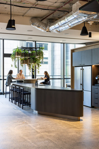 Modern office kitchen with employees