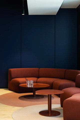 GEYER 201 George office lounge with rust-colored sofa and tables
