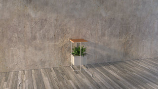 Grid-500 island console with plant against concrete wall.