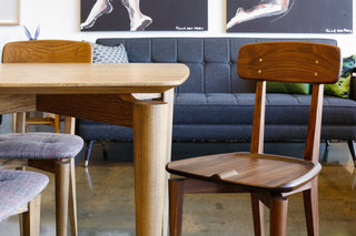 Wooden table and chair in modern living room setting.